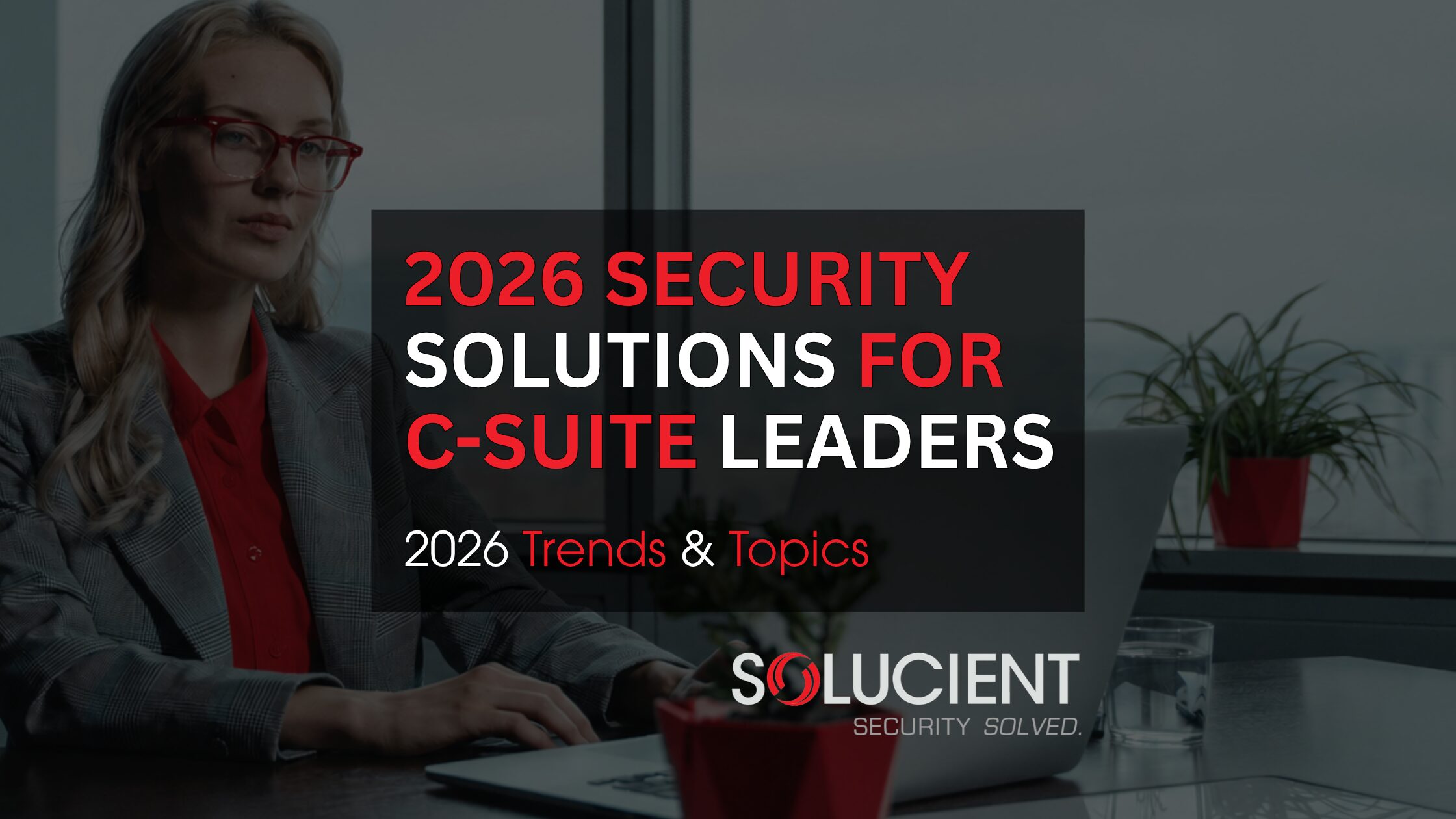 Blog Workplace Security Solutions For C-suite Executives Female executive on laptop - C-suite security solutions for Michigan leaders
