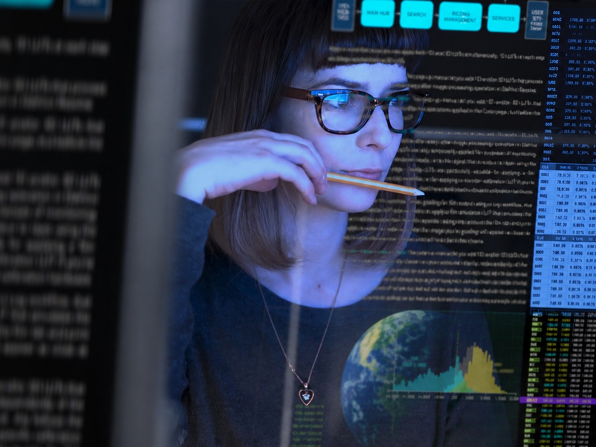 Girl in glasses looking at computer screen; Solucient Security Planning for Businesses; Free consultation in Michigan